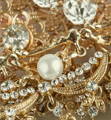 Evaluating Old and Broken Silver and Gold Jewelry Value Intricate pile of vintage gold and silver jewelry with pearl and rhinestone details
