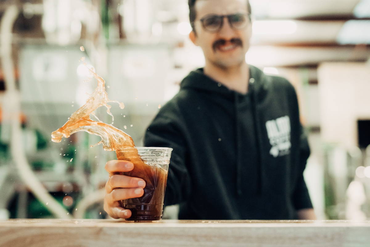 Man catching cup of flash brew coffee.