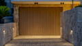 Havit outdoor wall lighting washing a stone-clad driveway and garage entry.