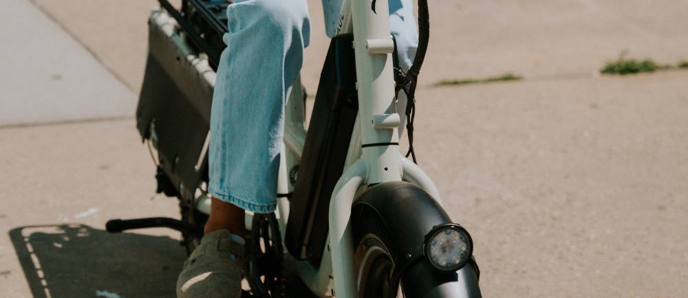 A woman close up riding an electric bike