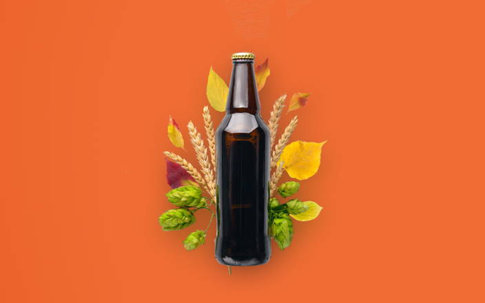 A big bottle of beer in front of hops, leaves, and stalks of wheat for Confetti's Oktoberfest Beer Tasting