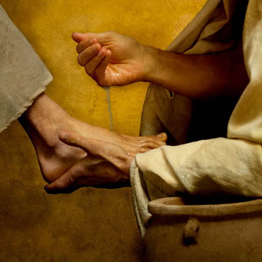 Up close painting of Jesus washing disciple's feet.
