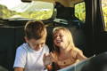 kids laughing in backseat of vehicle