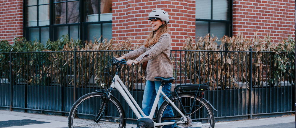woman standing next to an electric bike