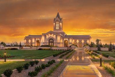 Fort Collins Temple against an orange and yellow sunset.