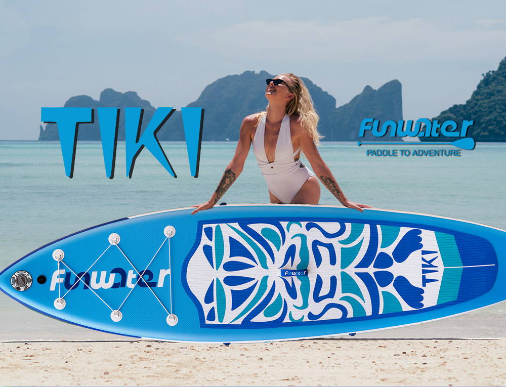 This woman is standing in front of the Funwater TIKI inflatable stand up paddle board