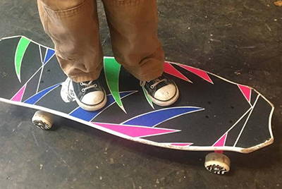 A person's feet on a skateboard