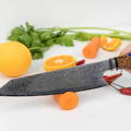 Chef's knife with fresh produce.