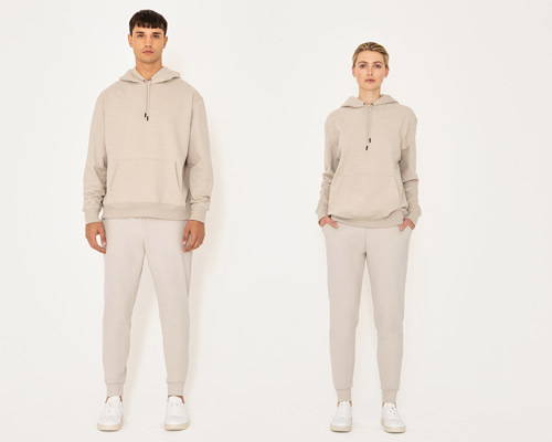 Man and woman wearing matching beige oversized hoodie and sweatpants made by sustainable streetwear brand Riley Studio 