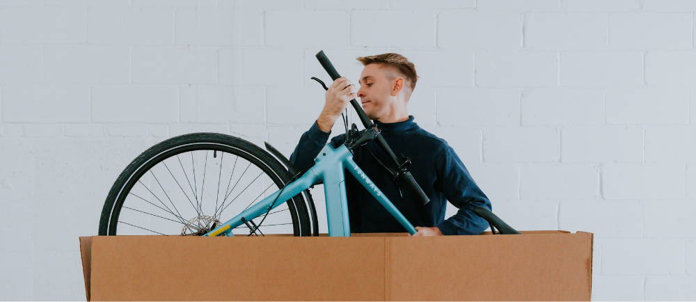 Man removing e-Bike from Upway box