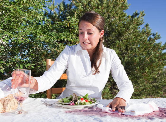 woman wiping spilled wine up with a napkin 