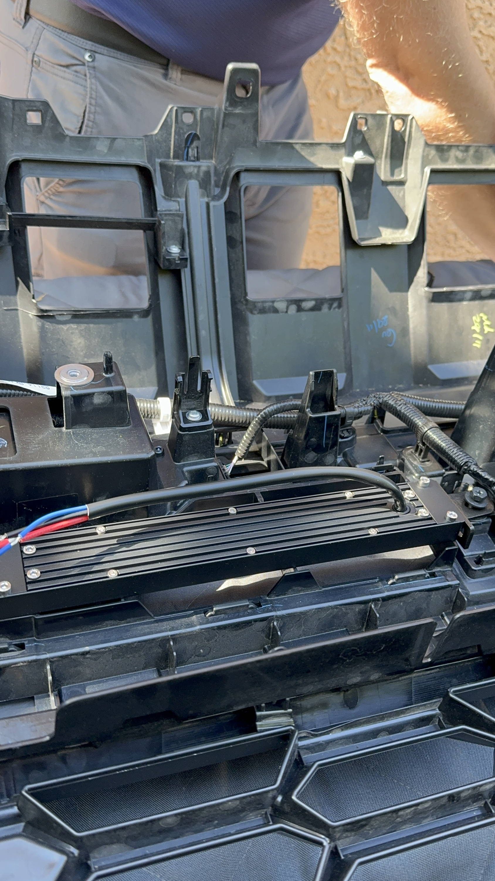 mike owner of m&R automotive tightens metal brackets for ford superduty off road light bar