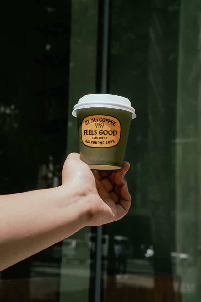 People sitting outside busy cafe 