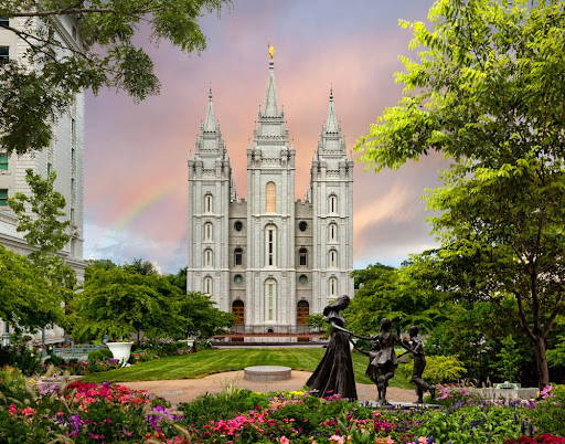 Picture of Salt Lake Temple grounds, featuring a statue of a young woman playing with two children.