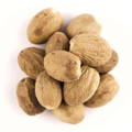 A cluster of whole nutmeg seeds arranged on a white background.