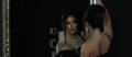 Elegantly dressed woman looking at herself in the mirror