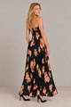 Model in a black floral print pleated strapless maxi dress - New Dresses