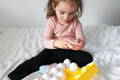 Little girl playing with Montessori Geometric Eggs.