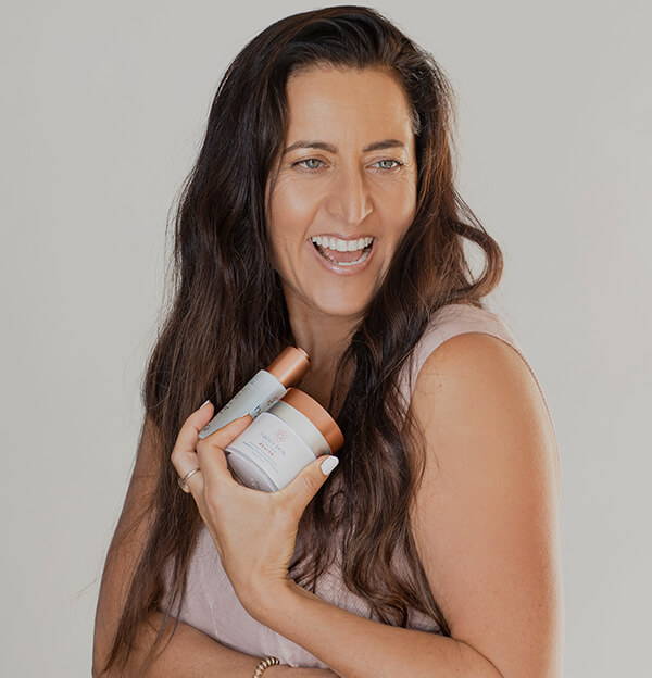 Woman Laughing Holding Happy Skin Products by Lisa Curry - Happy Healthy You