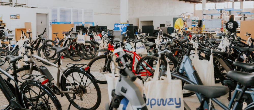 a collection of electric bikes at an Upway center