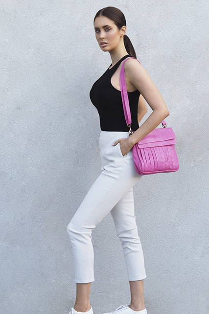 Cadelle Leather Lifestyle Photo White Leather Pants and Fuchsia Crossbody Bag