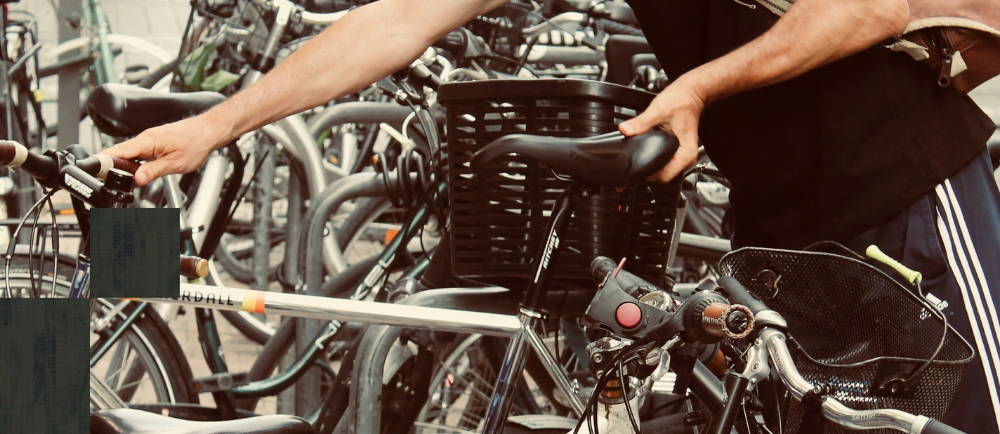 Rider removing bicycle from rack