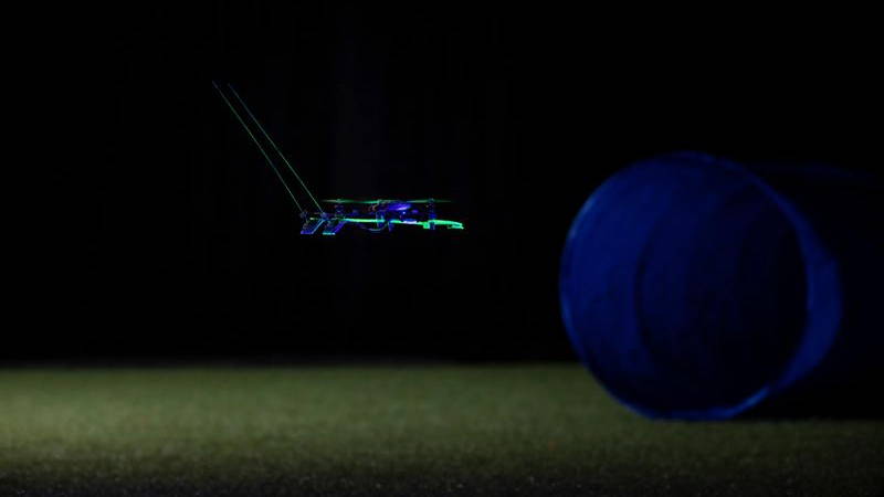 A drone moves towards an object in low light. the bottom of the drone is light green