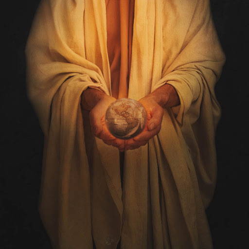Jesus holding a small globe in His hands.
