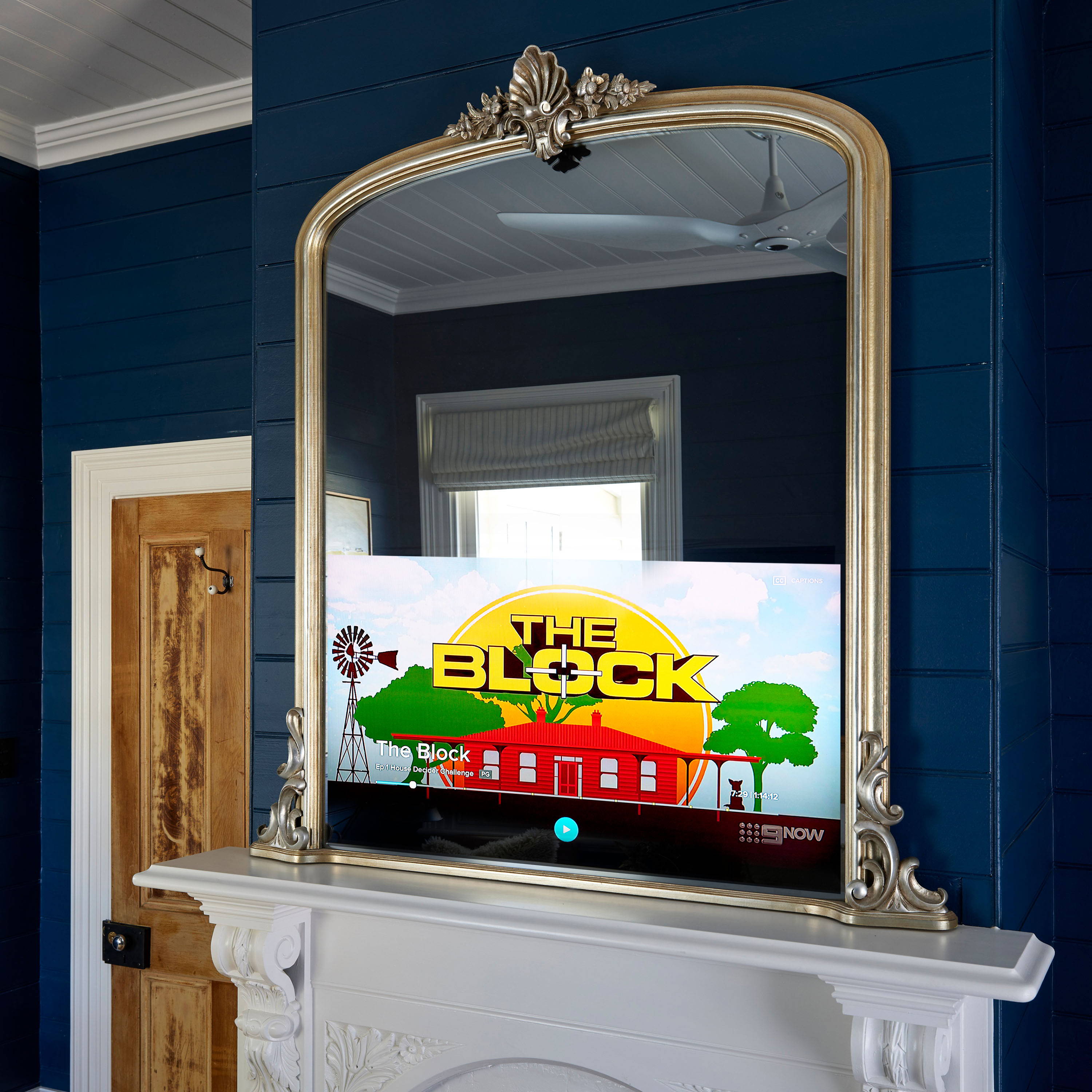 Victorian Arched TV-Mirror in Ornate Soft Silver Leaf Frame - An arched ornate mirror with hidden Samsung TV at the base.