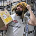Man Thinking while holding Mushroom Grow Kit Box