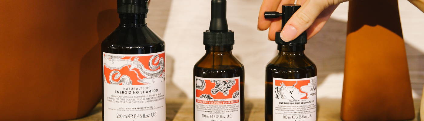 hand reaching for Davines ENERGIZING products for hair loss