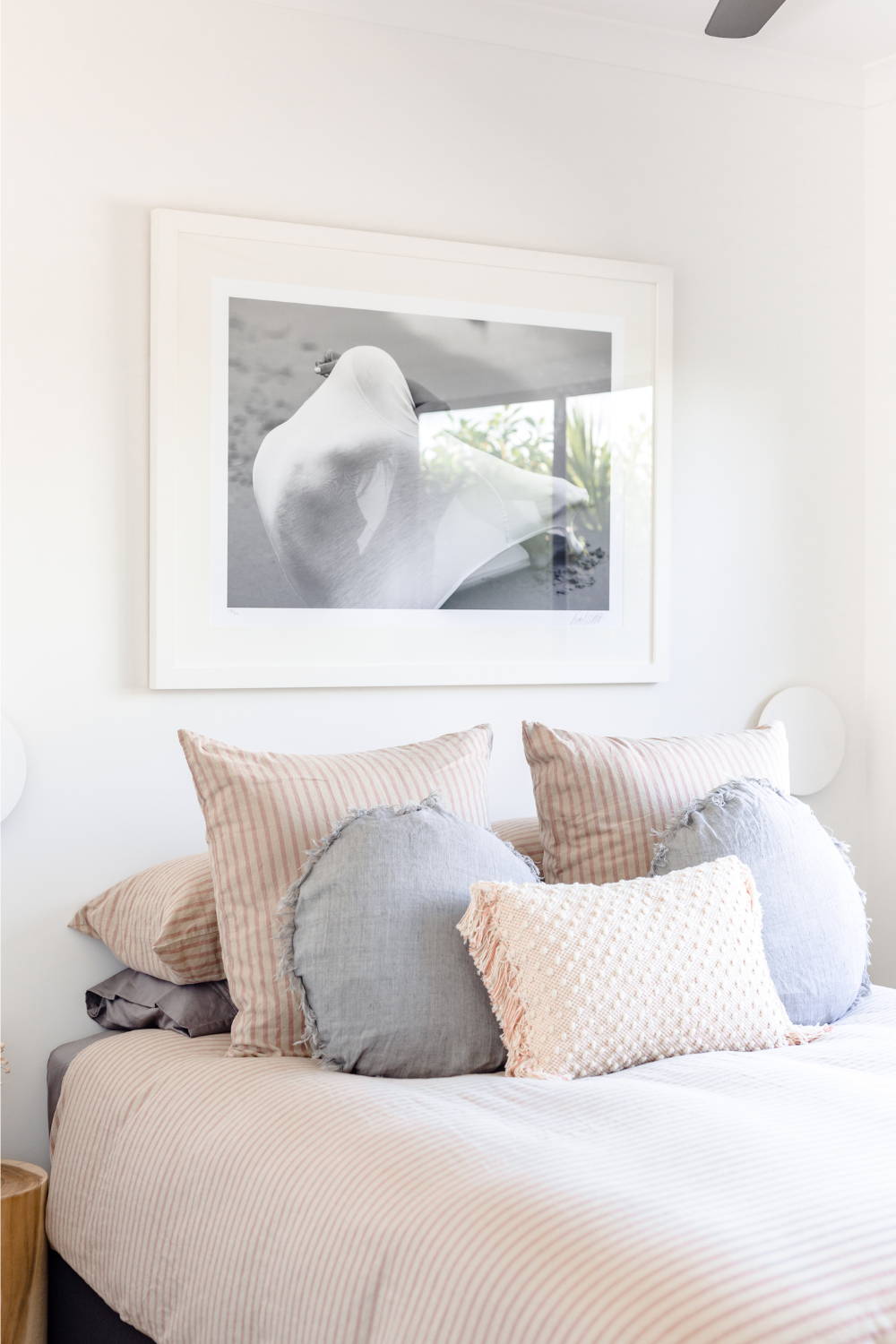 'Sea Shell' by Dina Broadhurst - A black and white photographic print of a nude figure on the beach, framed and styled in a bedroom setting