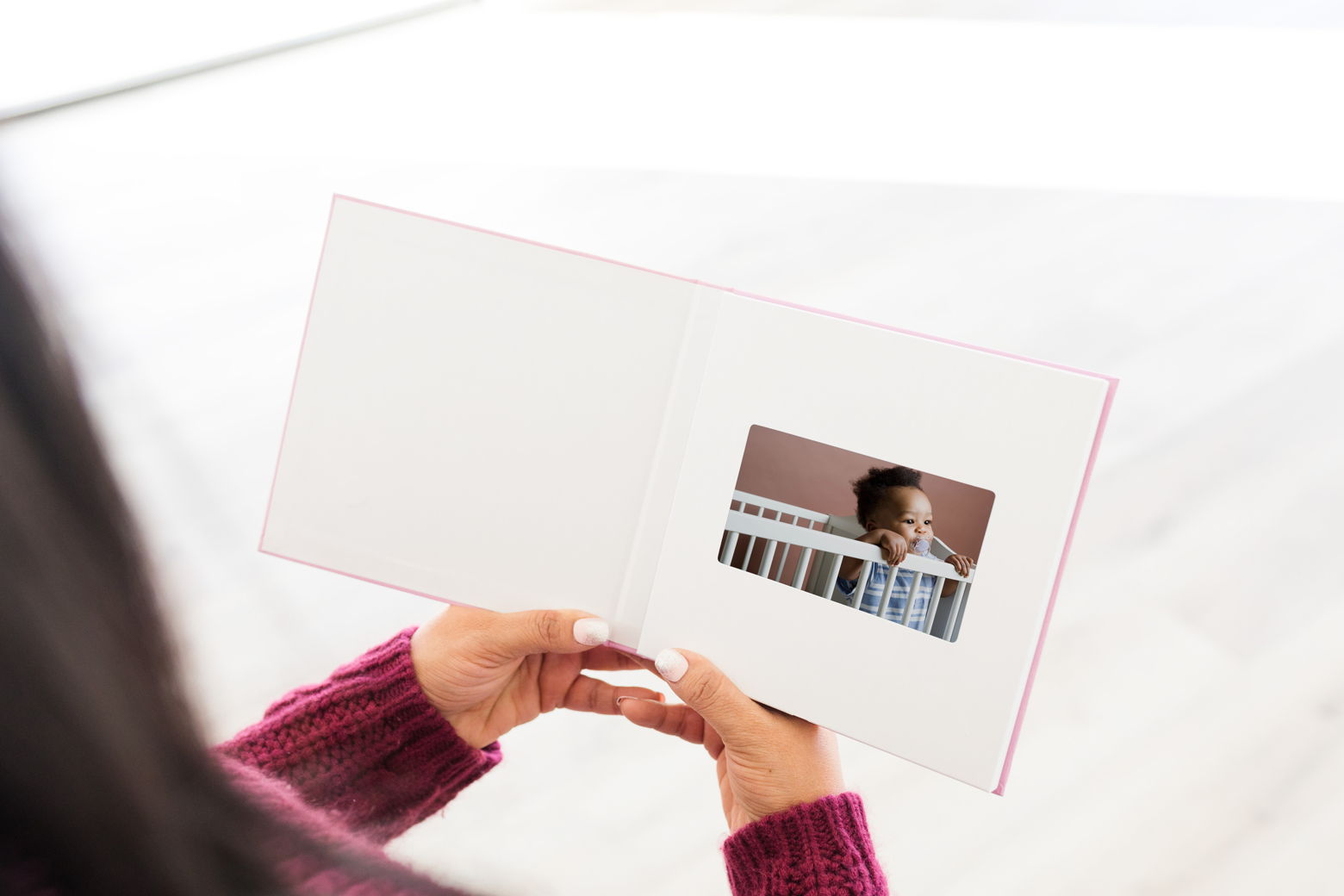 Video book of a baby being held by hands 