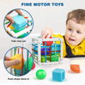 A little boy putting a red ball into a Montessori Shape Blocks toy. 