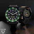 42mm DLC-black Classic case with leather strap and green bezel.