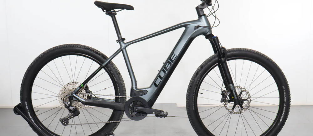 a silver Cube Reaction Hybrid Pro electric hardtail mountain bike