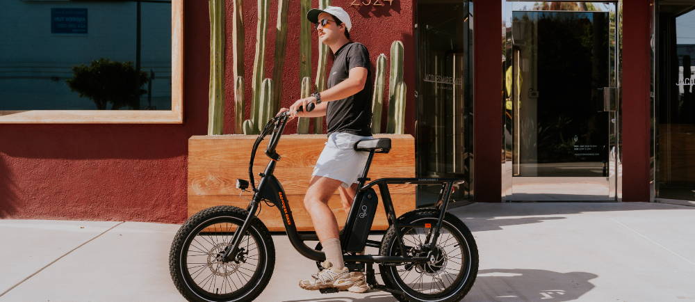 A man standing on an electric moto bike