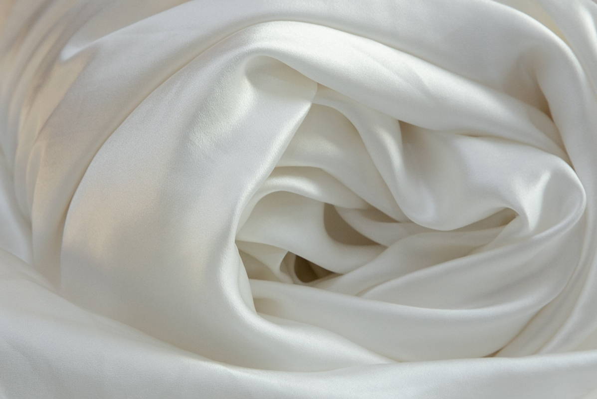 silk duvet cover rolled into a spiral