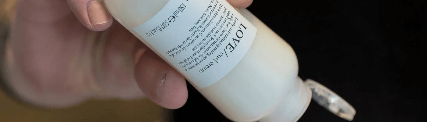 mini OI shampoo, OI milk, OI conditioner inside a packed suitcase