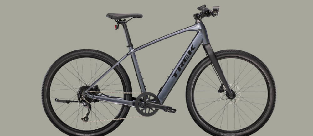 a silver Trek Dual Sport+ 2 electric city bike