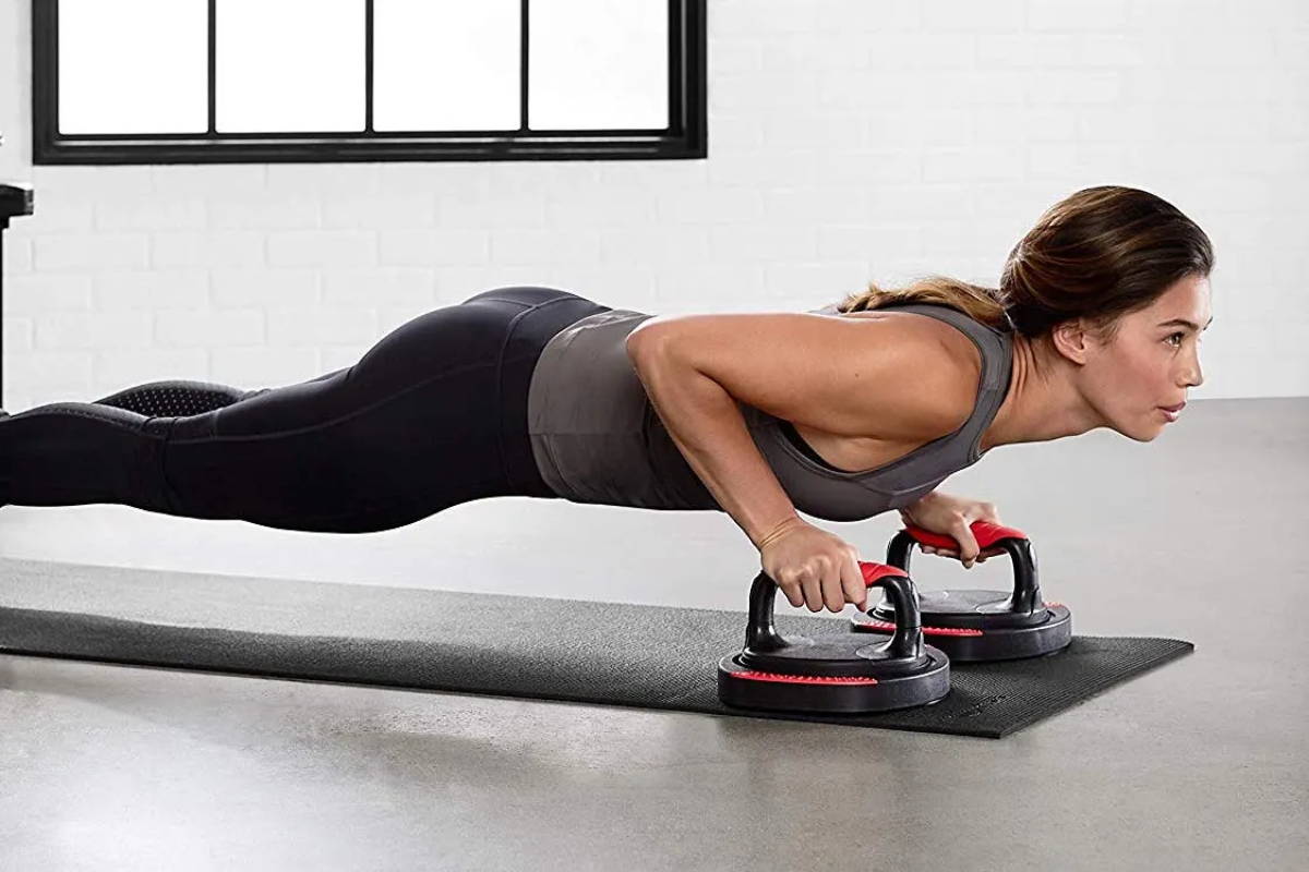 athlete exercising with push-up bars
