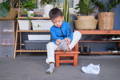 Kid putting on a sock by themselves
