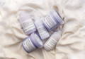 Davines LOVE/ Curl and LOVE Smoothing products lying on white silk sheets