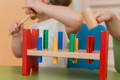 Little boy playing with a Montessori hammering toy. 