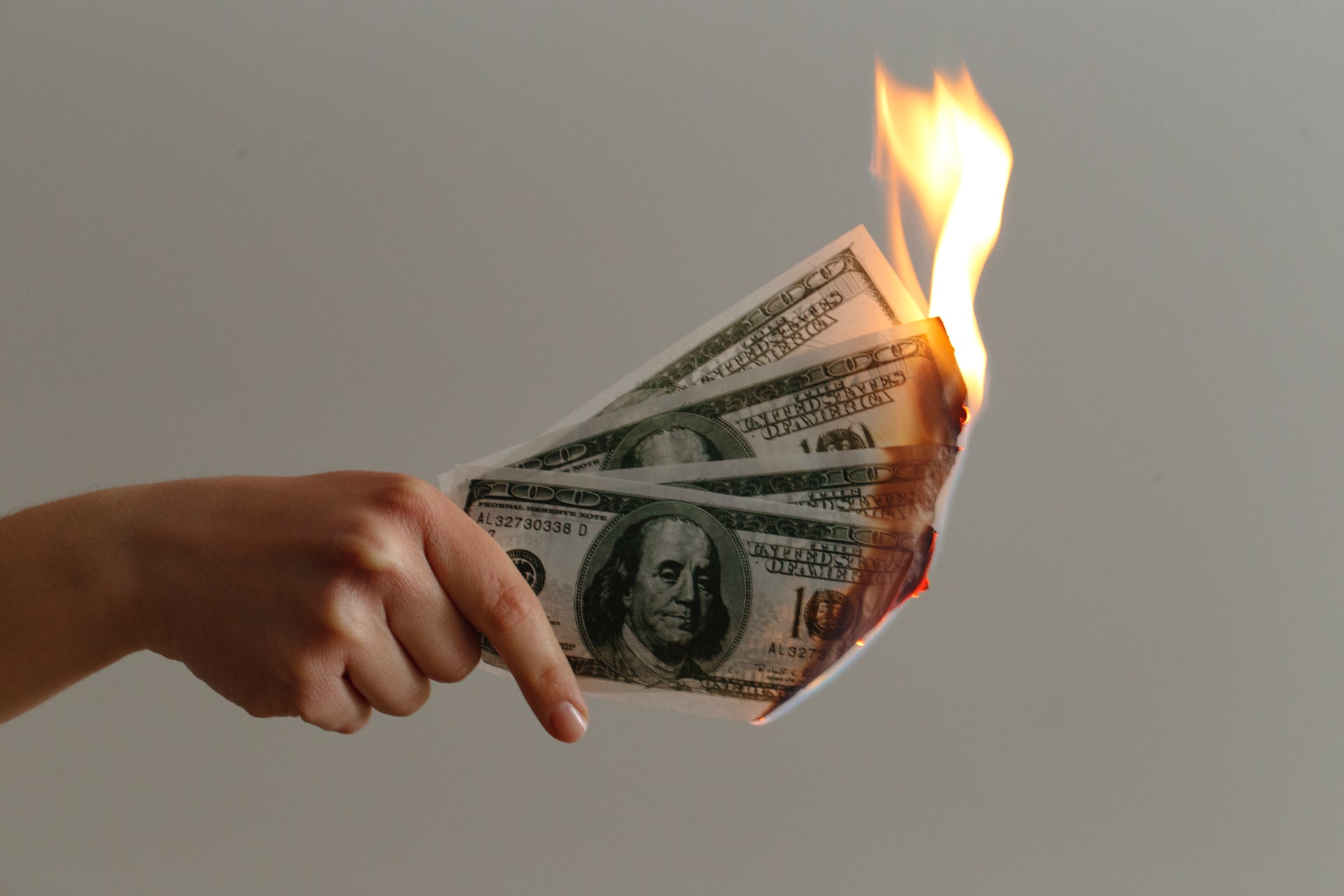 a fistful of burning money