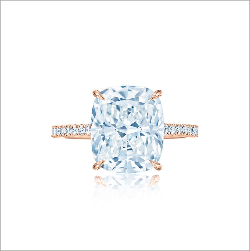 Prong set Kwiat cushion cut diamond engagement ring on a rose gold band. 