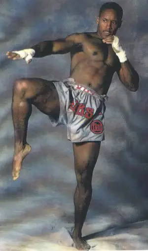 Chris Robinson posing for a Muay Thai promotion in boxing shorts and with hand wraps