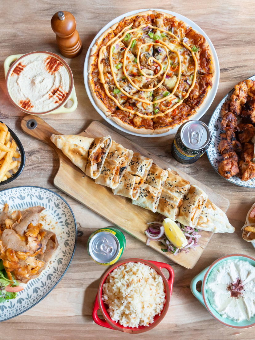 Sahara share spread: doner plate, Iskender, Turkish pide, pizza, dips, chips and charcoal skewers