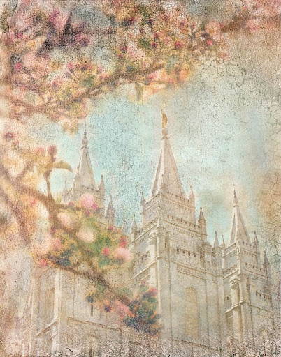 Salt Lake Temple standing behind pink blossom branches.