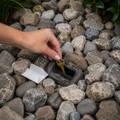 hand-hiding-house-key-inside-fake-rock hand-hiding-house-key-inside-fake-rock